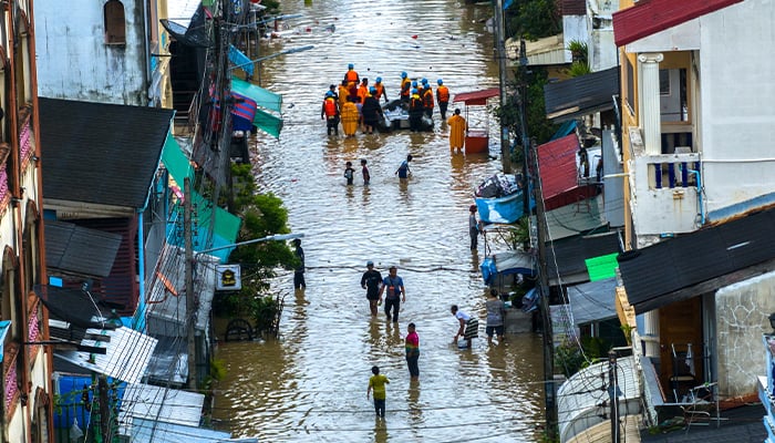 A drone view shows people wading through a flooded area in Hat Yai district, Songkhla province, Thailand, November 30, 2024. — Reuters