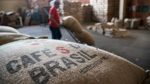 Getty Images A man working in a Brazilian coffee bean processing facility