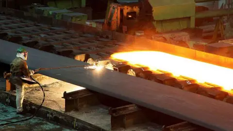 Getty Images A worker at a steelworks in Brazil