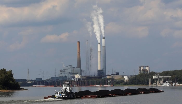A towboat pushes barges towards the Mill Creek Station power plant on the Ohio River in Louisville, Kentucky, US, September 15, 2017. — Reuters