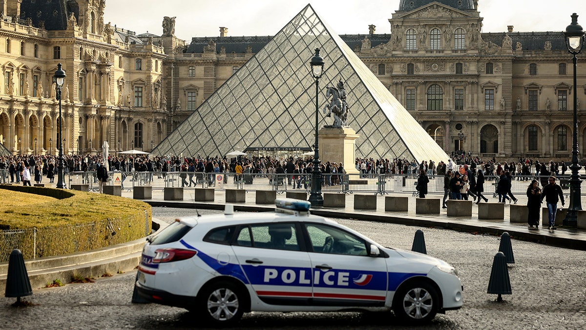 Police car parked outside Louvre Museum